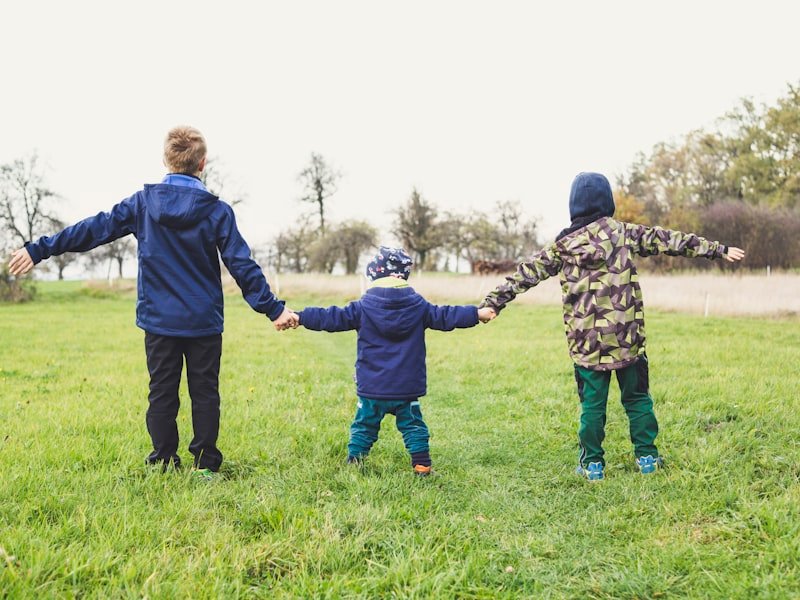 Children holding hands outdoors